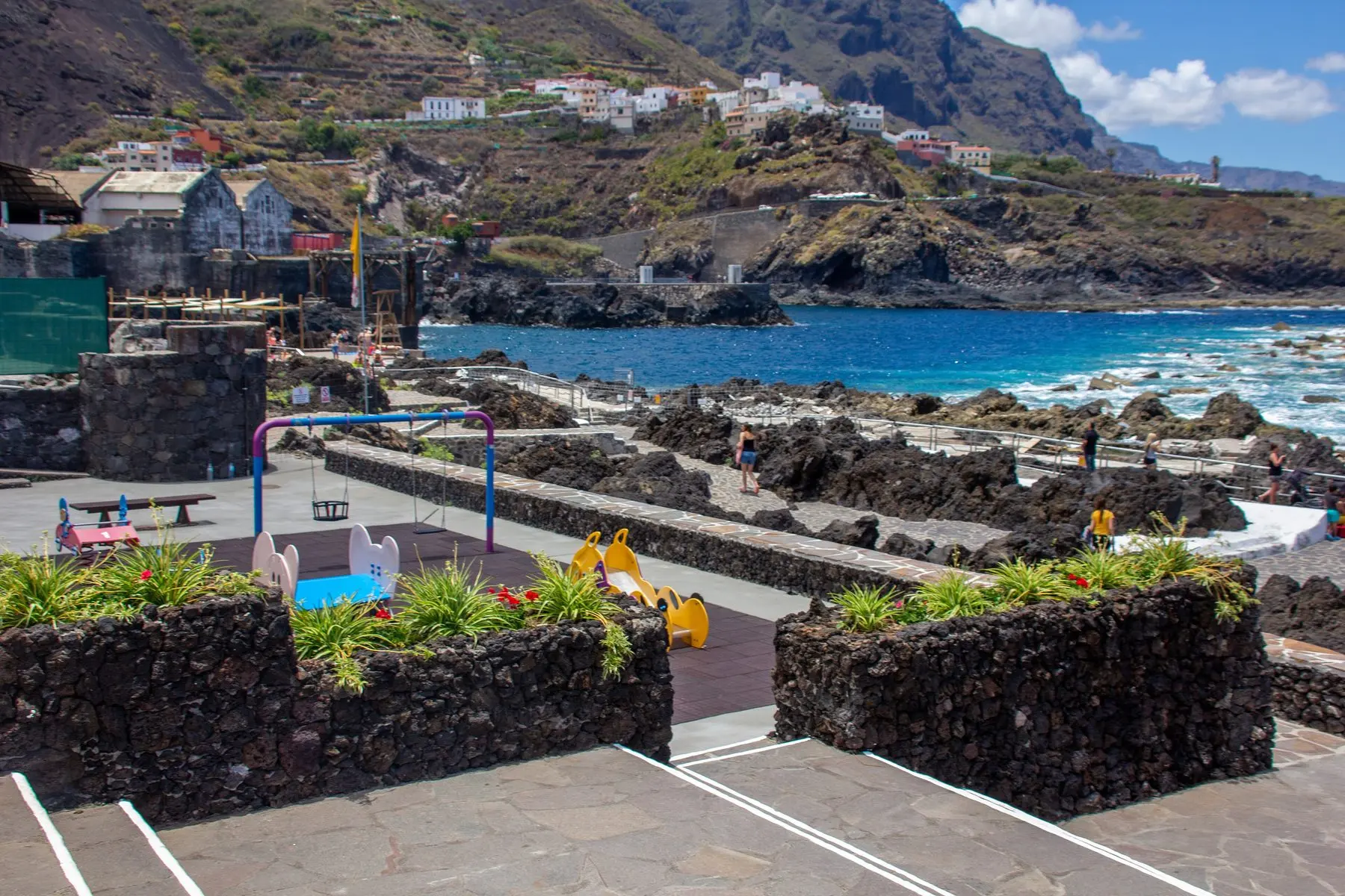 The natural lava pools of El Caletón in Garachico, with the town behind